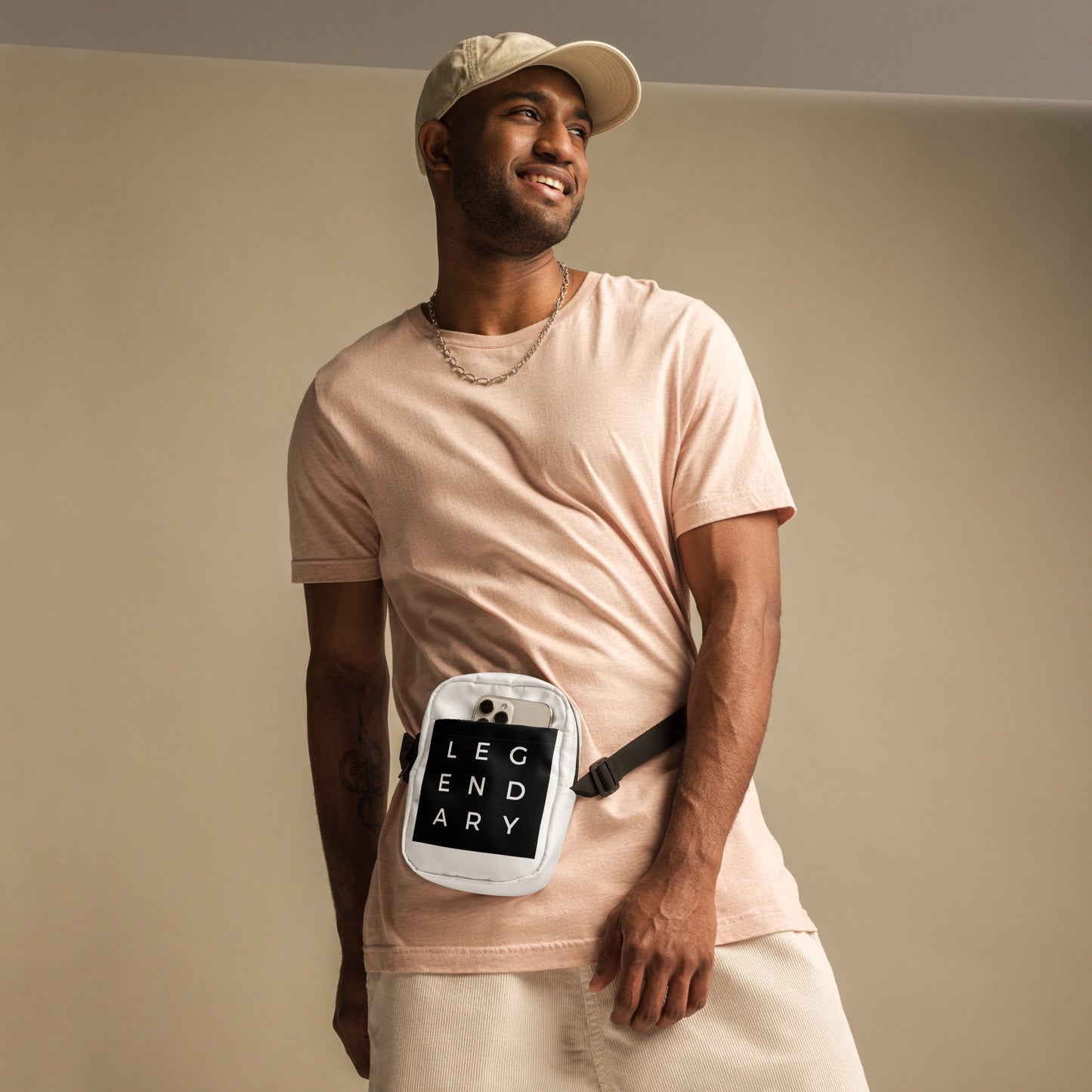
                  
                    White crossbody bag with black strap and front logo patch, worn across body
                  
                