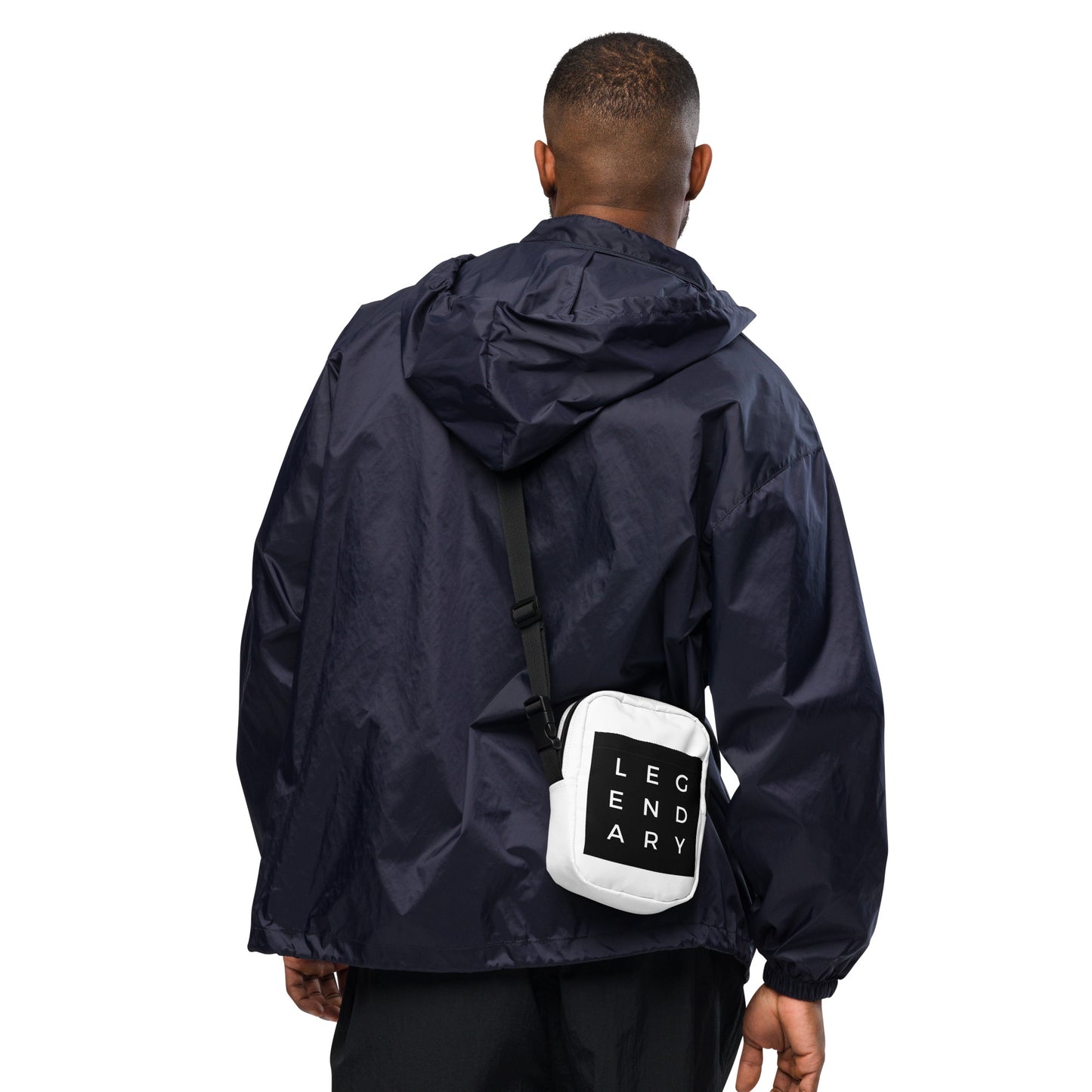 
                  
                    White utility crossbody bag with black strap and logo patch, worn on chest
                  
                