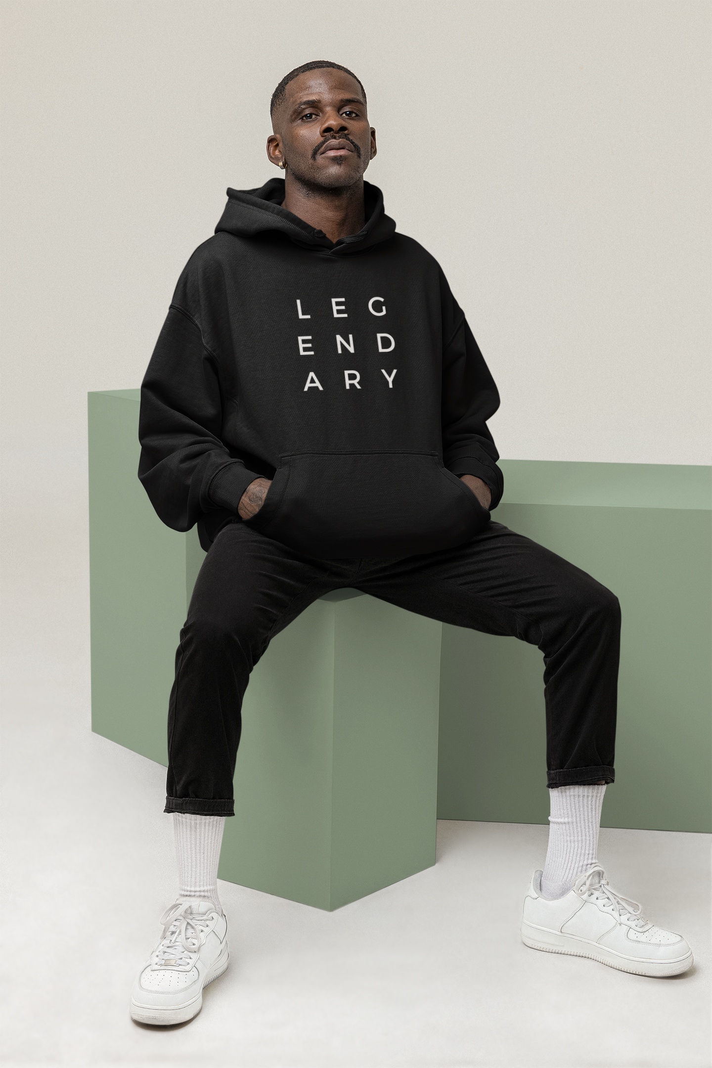 
                  
                    Unisex black hoodie with raised hood and small 'LEGENDARY' lettering on chest
                  
                