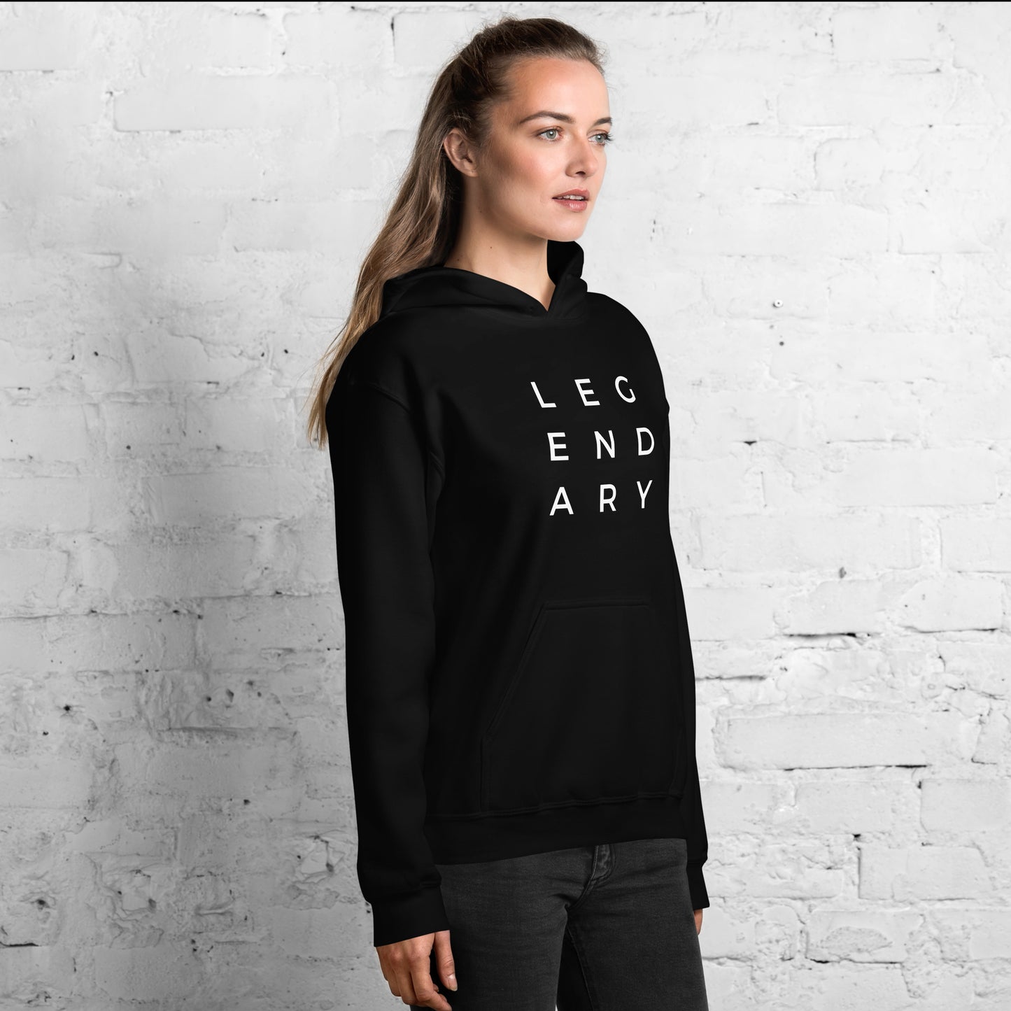 
                  
                    Unisex black hoodie with white LEGENDARY lettering, side view, hood and pocket
                  
                