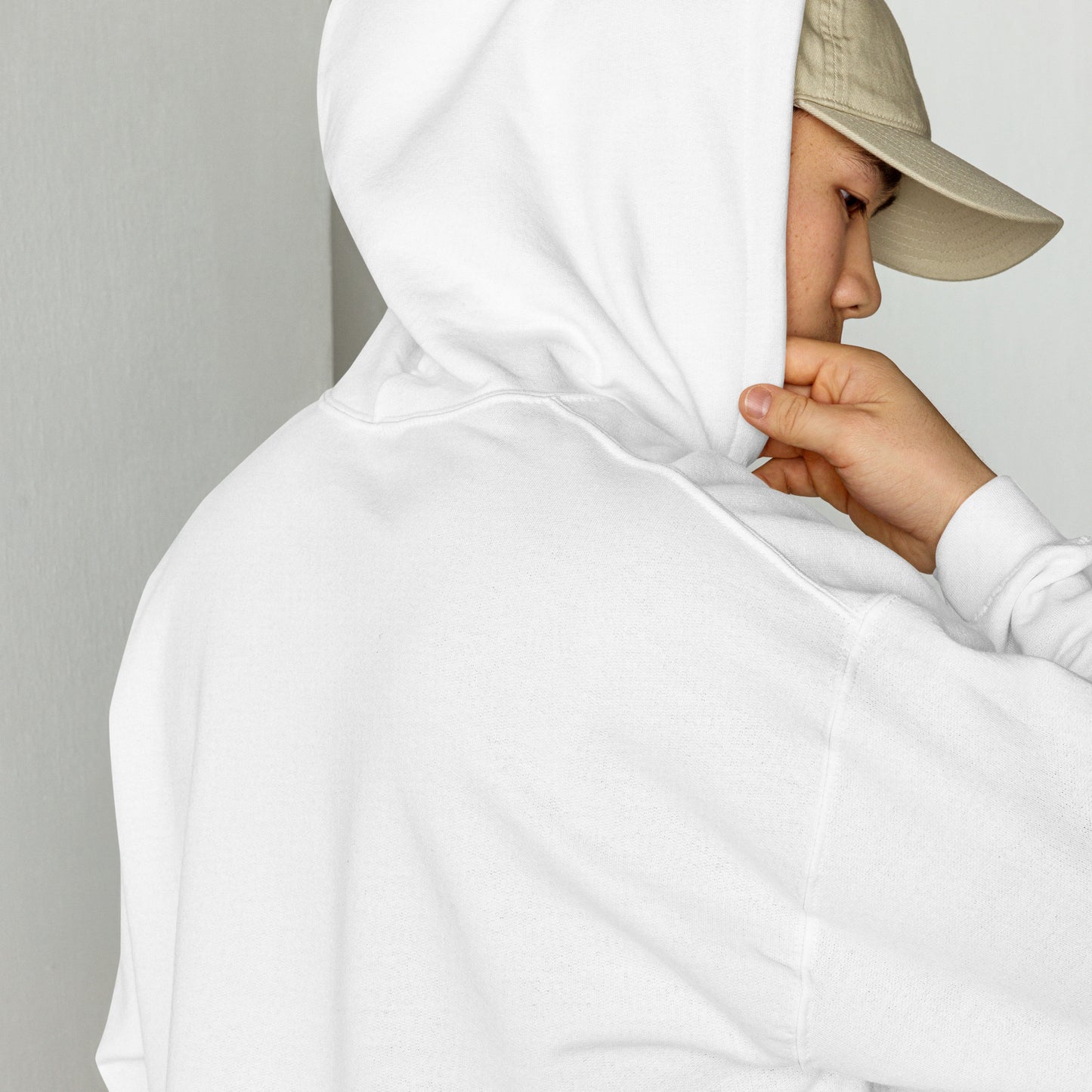 
                  
                    White hoodie with hood and drawstring, hands adjusting the hood
                  
                